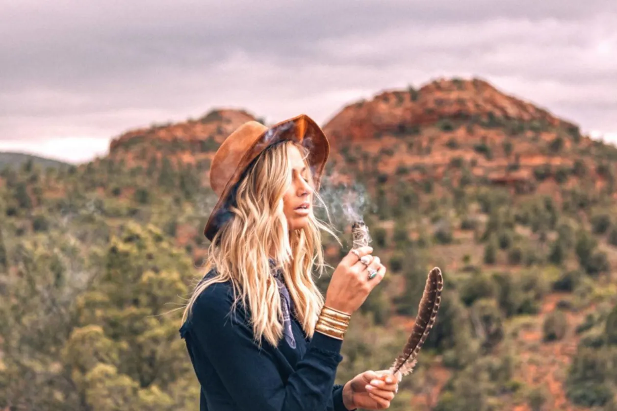woman burning sage sedona vortex as part of arizona itinerary